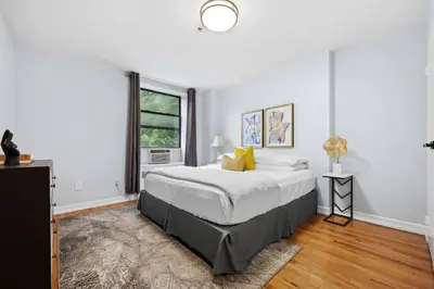 a white bedroom with a bed and a window at The Lenox in New York
