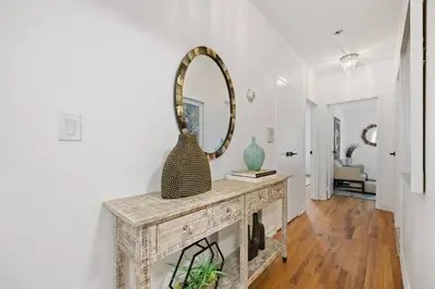 a mirror on a console table in a hallway at Harlem Renaissance in New York