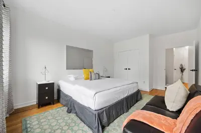 a bedroom with a large bed and a couch at Harlem Renaissance in New York