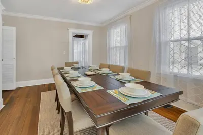 a dining room with a wooden table and chairs at Prime West Hartford Center- Timeless Charm in West Hartford