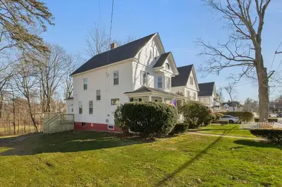 a large white house with a black roof at Prime West Hartford Center- Timeless Charm in West Hartford