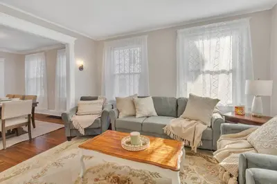 a living room with a couch and a table at Prime West Hartford Center- Timeless Charm in West Hartford