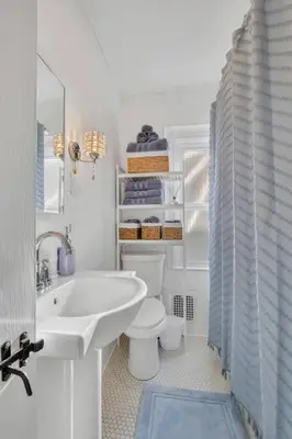 a white bathroom with a sink and a toilet at Prime West Hartford Center- Timeless Charm in West Hartford