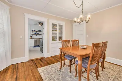 a dining room with a wooden table and chairs at Classic West Hartford Center Apartment in West Hartford