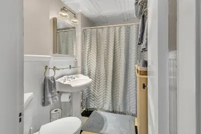 a bathroom with a sink and a toilet and a shower at Classic West Hartford Center Apartment in West Hartford