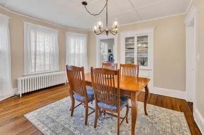a dining room with a wooden table and chairs at Classic West Hartford Center Apartment in West Hartford