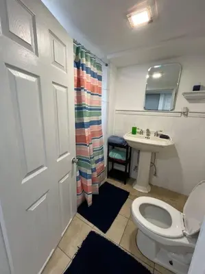 a bathroom with a toilet and a sink at 2 Bedroom Apartment By AirportS in Hillside