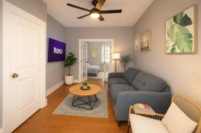 a living room with a couch and a table at Hoboken 15 Min Train to Manhattan Full Kitchen in Hoboken