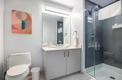 a bathroom with a toilet and a glass shower at Private Apt with Gym & Pool in Stamford