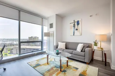 a living room with a couch and a glass table at Private Apt with Gym & Pool in Stamford
