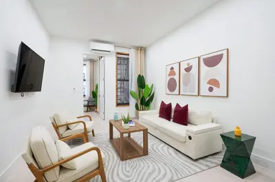 a living room with a white couch and chairs at 317-1D New 2BR Duplex WD Private Backyard in New York