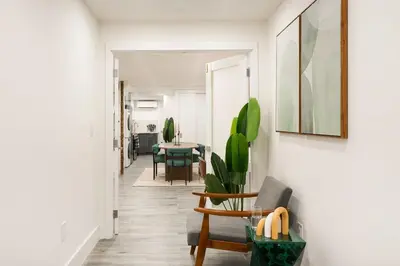 a hallway with a table and chairs in a room at 317-1D New 2BR Duplex WD Private Backyard in New York