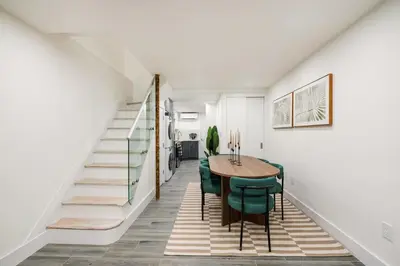 a dining room with a table and green chairs at 317-1D New 2BR Duplex WD Private Backyard in New York