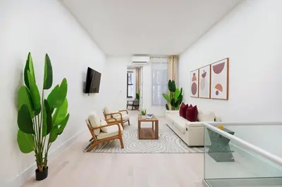a white living room with a couch and a table at 317-1D New 2BR Duplex WD Private Backyard in New York