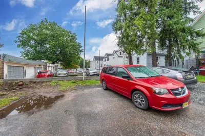 a red car parked in a parking lot at Perfect Private Unit in Passaic in Passaic