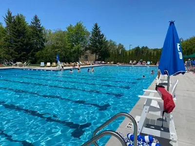 a large swimming pool with people in the water at The Beautiful & Cozy Malvec Chalet in Tobyhanna
