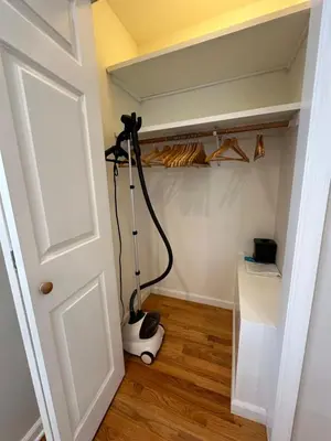 a room with a stand up vacuum in a room at Cozy studio quiet in Trumbull