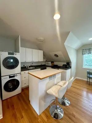a kitchen with a counter and a washer and dryer at Cozy studio quiet in Trumbull