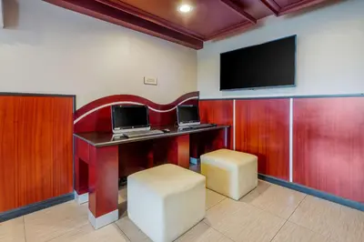 a room with a desk with a computer and a tv at BEST WESTERN PLUS Poconos in Tannersville