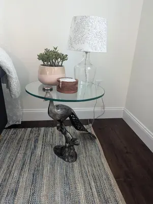 a glass table with a lamp and a vase on it at Tranquil Getaway Cottage in Charming, Bethel CT in Bethel