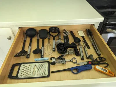 a drawer full of kitchen utensils on a counter at Tranquil Getaway Cottage in Charming, Bethel CT in Bethel
