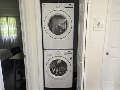 a washing machine and a dryer in a hallway at Tranquil Getaway Cottage in Charming, Bethel CT in Bethel