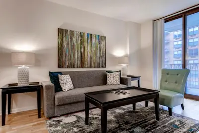 a living room with a couch and a table at Global Luxury Suites at Hoboken Waterfront in Hoboken