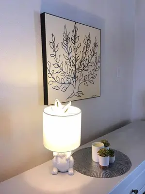 a lamp on a table with a picture on the wall at Catskill Cabin, Cool Apartment, 2nd Floor in Shandaken