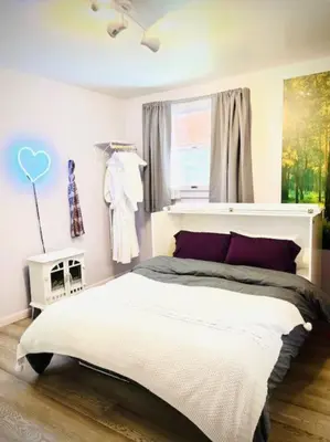 a bedroom with a large bed and a window at Catskill Cabin, Cool Apartment, 2nd Floor in Shandaken
