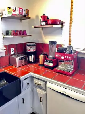 a kitchen with a red tiled counter top at Catskill Cabin, Cool Apartment, 2nd Floor in Shandaken