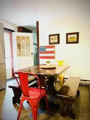 a kitchen with a table and chairs and an american flag at Catskill Cabin, Chill Apartment, 1st Fl in Shandaken