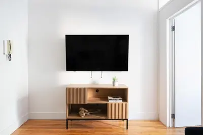 a living room with a tv on a white wall at 444-3A Newly renovated 1BR - Elevator Building in New York