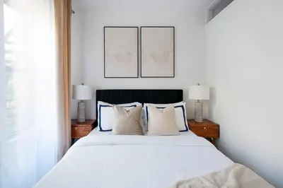 a bedroom with a large white bed with two lamps at 444-3A Newly renovated 1BR - Elevator Building in New York