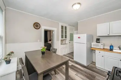 a kitchen with a table and a white refrigerator at Happiness in Harrison in Harrison