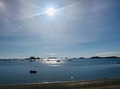 a large body of water with boats in it at Stylish Victorian Beach House on pond in Rowayton