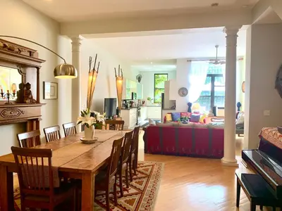 a dining room and living room with a table and chairs at 2 bedrooms with one private bathroom in lovely home in New York