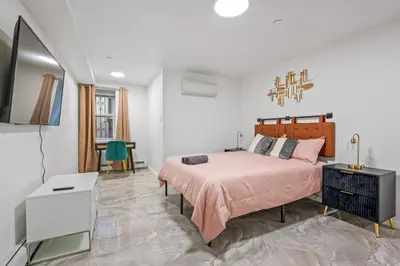a bedroom with a bed and a television in it at Active Central Park East 3bedrooms 2 bathrooms 1700 SF in New York