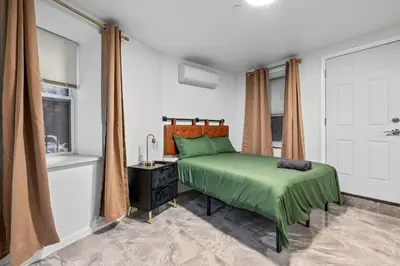 a bedroom with a green bed and a window at Active Central Park East 3bedrooms 2 bathrooms 1700 SF in New York