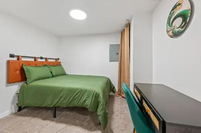 a small bedroom with a bed and a table at Active Central Park East 3bedrooms 2 bathrooms 1700 SF in New York