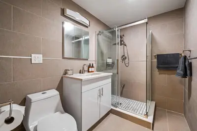 a bathroom with a toilet and a shower and a sink at Active Central Park East 3bedrooms 2 bathrooms 1700 SF in New York