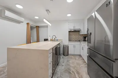 a kitchen with white cabinets and a large counter top at Active Central Park East 3bedrooms 2 bathrooms 1700 SF in New York