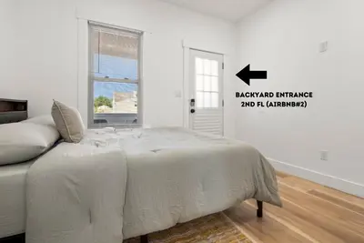 a white bedroom with a bed and a window at NYC Access 4BR Duplex Sleeps 10, Free Parking in Fair Lawn