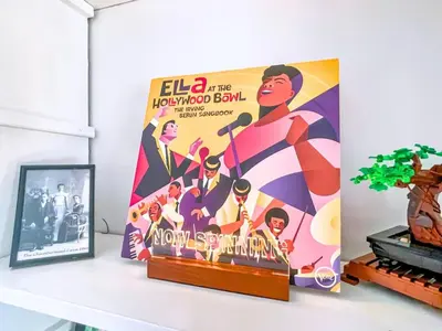 a shelf with a poster of elga the hollywood ball at The Jewel of The Cove - Historic Coastal Retreat in New Haven