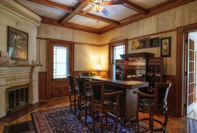 a room with a bar with chairs and a fireplace at Rockwell Falls Inn and Wine Bar in Lake Luzerne