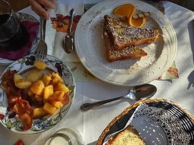 a table with two plates of food on it at Rockwell Falls Inn and Wine Bar in Lake Luzerne