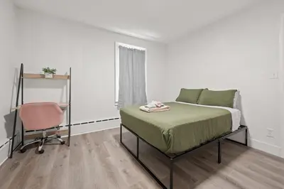 a bedroom with a bed and a chair at Downtown Hartford 2BR Family Pet Friendly in Hartford