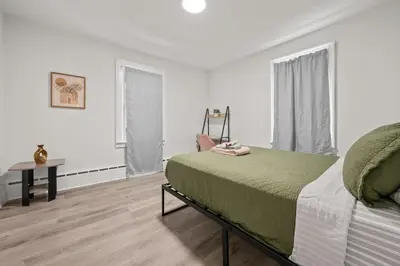 a bedroom with a bed and a table and a window at Downtown Hartford 2BR Family Pet Friendly in Hartford