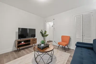 a living room with a blue couch and a tv at Downtown Hartford 2BR Family Pet Friendly in Hartford