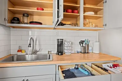 a kitchen with wooden cabinets and a sink at Downtown Hartford 2BR Family Pet Friendly in Hartford