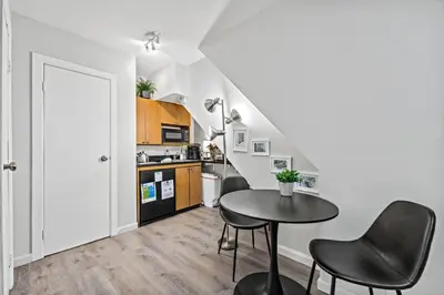 a kitchen with a table and chairs in a room at Central Location Studio, Walk to Times Square in New York